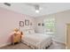 Bright bedroom features a ceiling fan, floral bedding, and decor, creating a cozy and inviting atmosphere at 27147 Guapore Dr, Punta Gorda, FL 33983