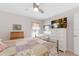 Comfortable bedroom featuring a bed, wooden desk, TV, and soft, natural lighting at 27147 Guapore Dr, Punta Gorda, FL 33983