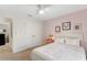 Bedroom features a bed with pink accents, neutral walls, and a spacious closet, combining comfort and functionality at 27147 Guapore Dr, Punta Gorda, FL 33983