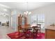 Dining room with a wood table, four chairs, a hutch, and a chandelier at 27147 Guapore Dr, Punta Gorda, FL 33983