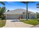 Inviting one-story home featuring manicured lawn, two-car garage, and stylish front entrance at 27147 Guapore Dr, Punta Gorda, FL 33983