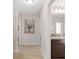 Hallway view into bathroom with granite countertop and wood cabinetry at 27147 Guapore Dr, Punta Gorda, FL 33983
