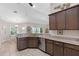 Open-concept kitchen with speckled granite countertops, stainless steel appliances, and modern lighting at 27147 Guapore Dr, Punta Gorda, FL 33983