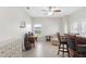 Well-lit living room with a ceiling fan, desk, and decorative wall art at 27147 Guapore Dr, Punta Gorda, FL 33983