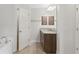 Well lit main bathroom featuring granite counters, a soaking tub and a wooden cabinet at 27147 Guapore Dr, Punta Gorda, FL 33983