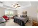 Bright main bedroom with ceiling fan, neutral walls and a comfortable sitting area at 27147 Guapore Dr, Punta Gorda, FL 33983