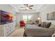 Bright main bedroom features a large TV, sitting area, and plenty of natural light at 27147 Guapore Dr, Punta Gorda, FL 33983