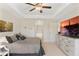 Spacious main bedroom with ceiling fan, television, and ensuite bathroom access at 27147 Guapore Dr, Punta Gorda, FL 33983