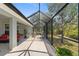 Large screened patio includes an outdoor seating area with grill, offering an open-air space for entertaining or relaxation at 27147 Guapore Dr, Punta Gorda, FL 33983