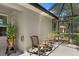Covered patio with seating offers a relaxing outdoor space with screened enclosure and views of the lush backyard at 27147 Guapore Dr, Punta Gorda, FL 33983