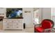 Cozy sitting area with flat screen television, drawers, and a view of the lanai at 27147 Guapore Dr, Punta Gorda, FL 33983