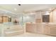 Bathroom features a luxurious bathtub, double sinks, and plenty of storage with mirrored walls at 283 Fields Se Ter, Port Charlotte, FL 33952