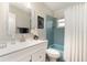 Stylish bathroom with blue tiles, a tub and shower combo, and a large vanity at 283 Fields Se Ter, Port Charlotte, FL 33952