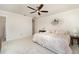 Bright bedroom featuring a ceiling fan, neutral walls and carpet, and an en suite bathroom at 283 Fields Se Ter, Port Charlotte, FL 33952