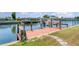 Wooden dock with boat lift on a canal, ideal for boating enthusiasts at 283 Fields Se Ter, Port Charlotte, FL 33952