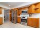 Well-equipped kitchen featuring stainless steel appliances and classic wood cabinetry at 283 Fields Se Ter, Port Charlotte, FL 33952