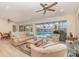 Bright living room with a view of the screened-in pool, patio and landscaped yard at 283 Fields Se Ter, Port Charlotte, FL 33952