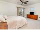 Main bedroom with neutral carpet and a sliding glass door to the outside at 283 Fields Se Ter, Port Charlotte, FL 33952