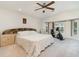 Large bedroom with a mirrored headboard and an exercise bike beside bright windows at 283 Fields Se Ter, Port Charlotte, FL 33952