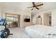 A bright bedroom has sliding glass doors which provide views of the outdoor pool and patio at 283 Fields Se Ter, Port Charlotte, FL 33952