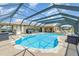 Sparkling pool in a screened enclosure, with ample deck space for lounging at 283 Fields Se Ter, Port Charlotte, FL 33952