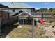 Fenced backyard with a pet enclosure, perfect for outdoor relaxation and pet ownership at 376 Waterside St, Port Charlotte, FL 33954