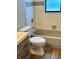 Bathroom features a tub and toilet with gray accents and wood-look flooring at 376 Waterside St, Port Charlotte, FL 33954