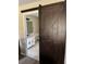 Bathroom with dark-stained barn door, white cabinets, and modern fixtures at 376 Waterside St, Port Charlotte, FL 33954