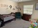 Bedroom with crib, accent chair, changer, and neutral walls at 376 Waterside St, Port Charlotte, FL 33954