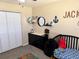 Bedroom featuring crib, dresser, beanbag chair, and stylish decor at 376 Waterside St, Port Charlotte, FL 33954