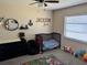Bedroom with modern crib, soft rug, and colorful toy decor at 376 Waterside St, Port Charlotte, FL 33954
