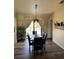 Dining room features dark table and chairs with elegant light fixture at 376 Waterside St, Port Charlotte, FL 33954