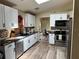 Updated kitchen features white cabinets, black countertops, stainless steel appliances, and modern finishes at 376 Waterside St, Port Charlotte, FL 33954
