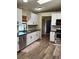 Modern kitchen featuring stainless steel appliances, sleek black counters, and ample white cabinetry at 376 Waterside St, Port Charlotte, FL 33954