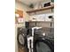 Laundry room with Samsung washer and dryer, floating shelves, and decor at 376 Waterside St, Port Charlotte, FL 33954