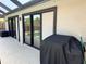 Covered outdoor patio with sliding glass doors leads to the refreshing pool at 376 Waterside St, Port Charlotte, FL 33954