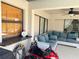 Covered outdoor space with wicker sofa and a patio bar for relaxed entertainment at 376 Waterside St, Port Charlotte, FL 33954