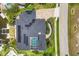 Aerial view of a luxury home featuring a private pool, boat lift, and manicured landscaping at 3866 Turtle Dove Blvd, Punta Gorda, FL 33950