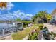 Beautiful backyard view with boat lift, lush landscaping, and a charming waterfront setting at 3866 Turtle Dove Blvd, Punta Gorda, FL 33950