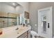 Bathroom with shower, sink, toilet, and plenty of natural light from the glass door to the exterior at 3866 Turtle Dove Blvd, Punta Gorda, FL 33950