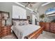 This cozy bedroom features an accent wall, wood furniture, and a large window with outdoor views at 3866 Turtle Dove Blvd, Punta Gorda, FL 33950