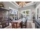Elegant dining room with a large table, stylish chairs, and views of the outdoor patio and waterfront at 3866 Turtle Dove Blvd, Punta Gorda, FL 33950