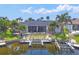 Beautiful waterfront home featuring a private boat lift and lush tropical landscaping at 3866 Turtle Dove Blvd, Punta Gorda, FL 33950