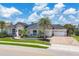 Beautiful single-story home with a paver driveway, tropical landscaping, and a two-car garage at 3866 Turtle Dove Blvd, Punta Gorda, FL 33950