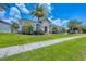 Well-maintained single-story home featuring a lush green lawn and tropical landscaping at 3866 Turtle Dove Blvd, Punta Gorda, FL 33950