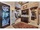 Hallway features elegant stone walls, detailed doorway, and a view into the spacious living areas at 3866 Turtle Dove Blvd, Punta Gorda, FL 33950