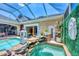 Covered hot tub area with stone waterfall feature, elegant decor, and bright natural light at 3866 Turtle Dove Blvd, Punta Gorda, FL 33950
