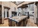 Open-concept kitchen with a large granite island, stone accents, and seamless flow into the living area at 3866 Turtle Dove Blvd, Punta Gorda, FL 33950