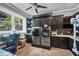 Modern laundry room with front loading washer and dryer, lots of cabinetry, and counter space at 3866 Turtle Dove Blvd, Punta Gorda, FL 33950
