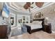 This elegant main bedroom boasts a brick accent wall, trey ceilings, and access to the pool and patio at 3866 Turtle Dove Blvd, Punta Gorda, FL 33950